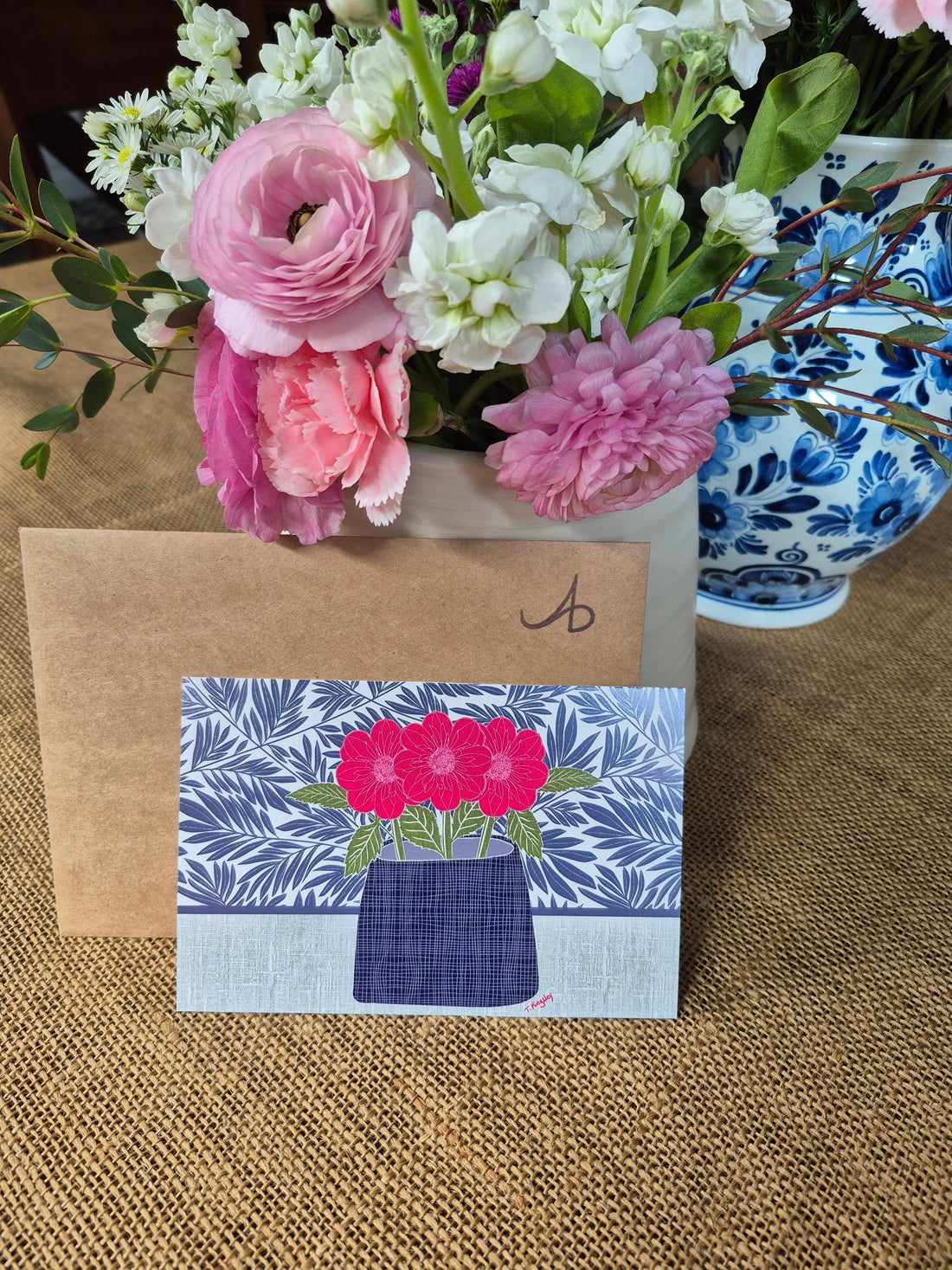 Letter to mom next to floral artwork and a flower arrangement.
