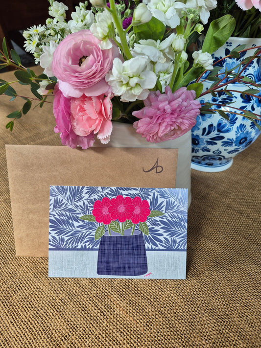 Letter to mom next to floral artwork and a flower arrangement.