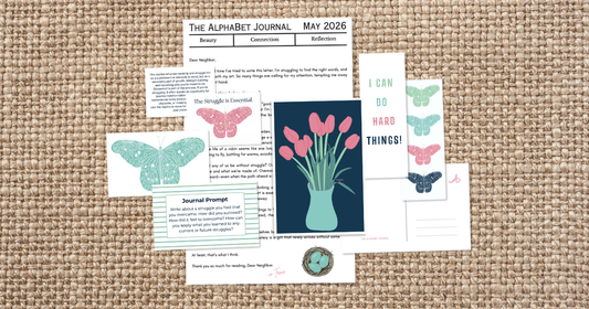 Flat lay of The AlphaBet Journal May 2026 snail mail mailer including a personal letter, tulip artwork, moth illustrations, journal prompt card, and I Can Do Hard Things bookmark on burlap